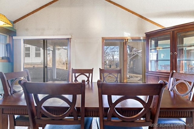 dining area featuring lofted ceiling and a wealth of natural light