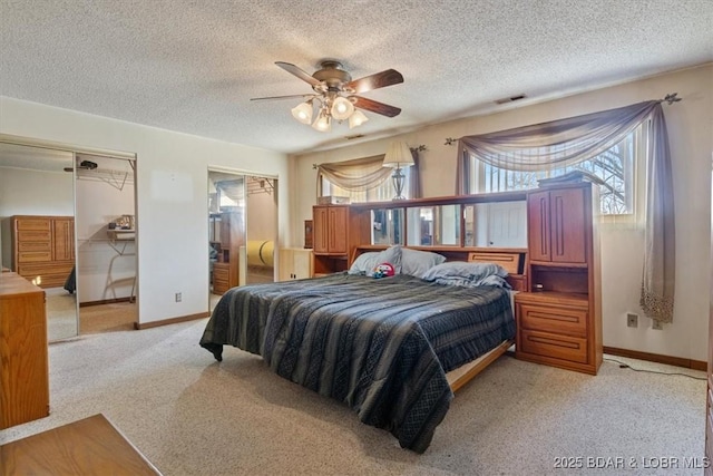 bedroom with multiple windows, a textured ceiling, and ceiling fan