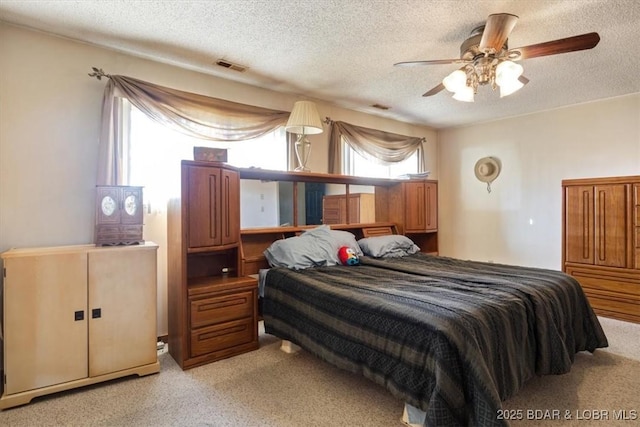 bedroom with a textured ceiling and ceiling fan