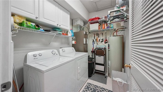 washroom featuring cabinets, light tile patterned floors, washer and clothes dryer, and water heater