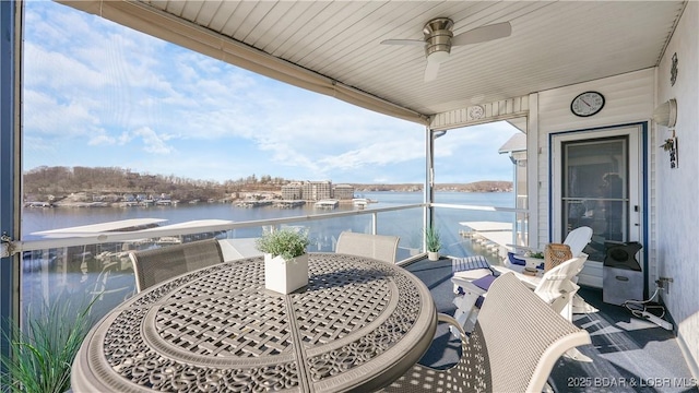 balcony featuring a water view and ceiling fan