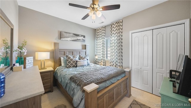 bedroom with light carpet, a closet, and ceiling fan