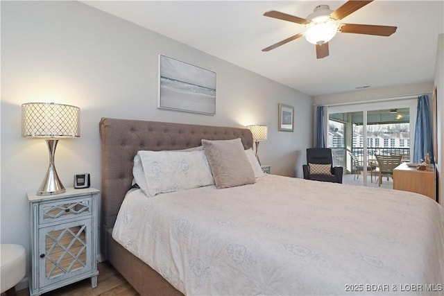 bedroom featuring hardwood / wood-style flooring, ceiling fan, and access to exterior