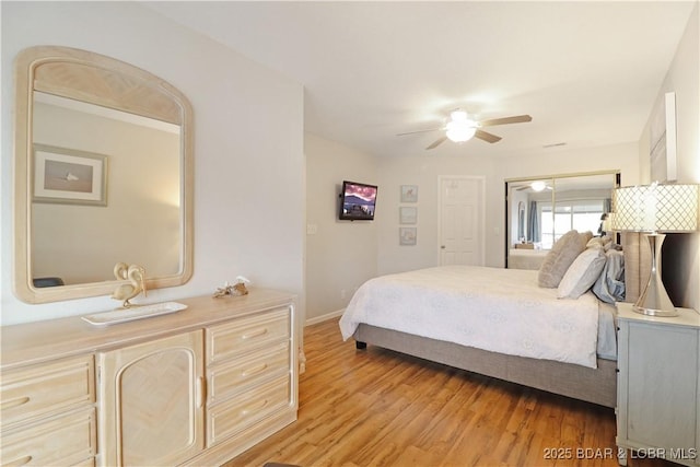 bedroom featuring ceiling fan, light hardwood / wood-style floors, and a closet