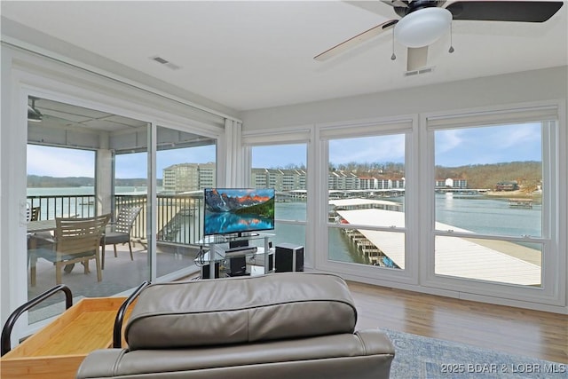 sunroom / solarium featuring ceiling fan