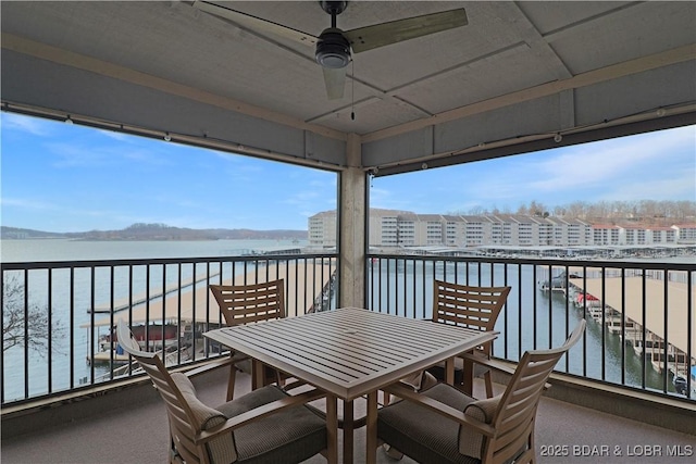 balcony with a water view and ceiling fan