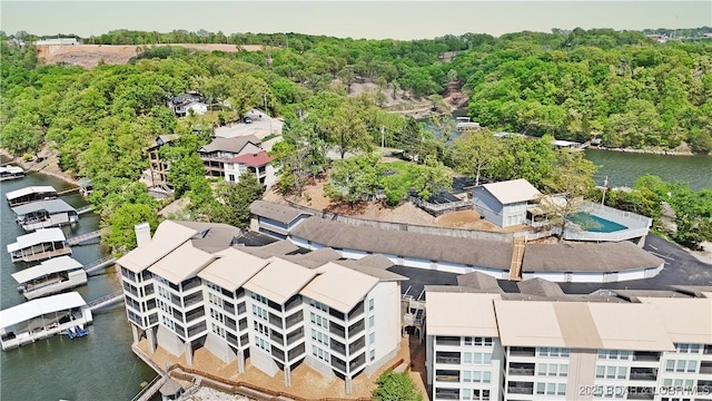 drone / aerial view with a water view and a view of trees