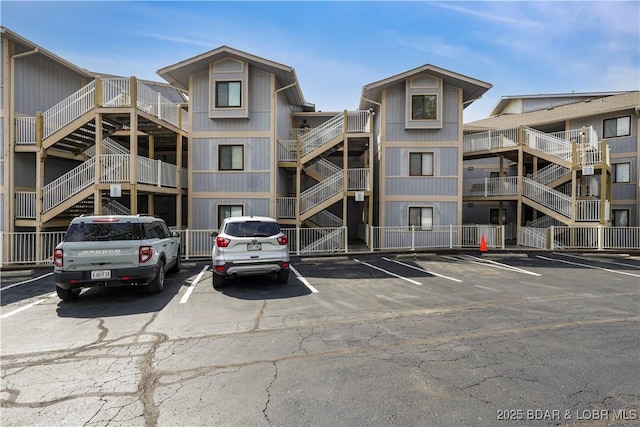 view of building exterior with uncovered parking