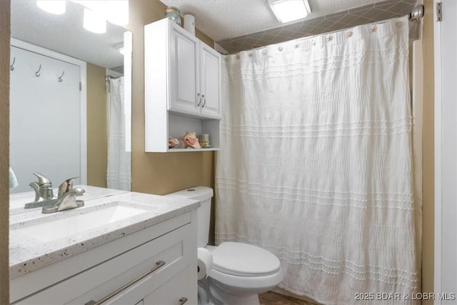 bathroom with vanity, a shower with shower curtain, a textured ceiling, and toilet