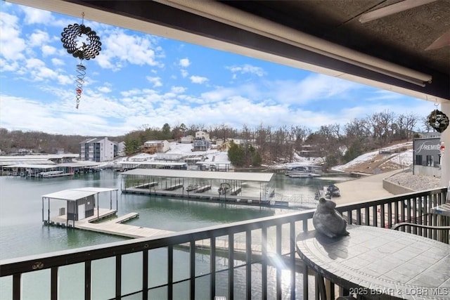 balcony featuring a water view and a dock