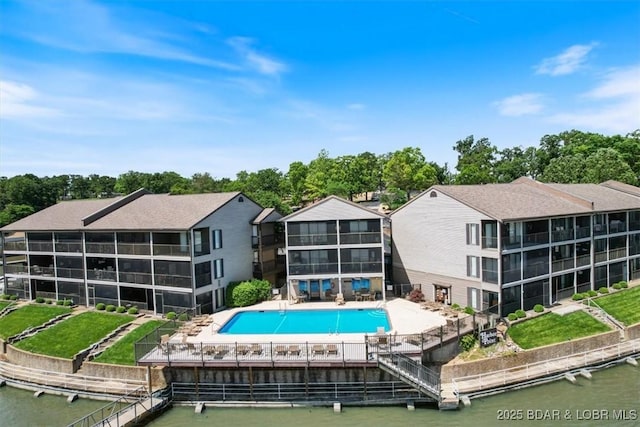 back of house featuring a community pool