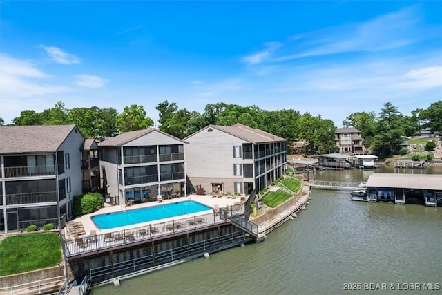 rear view of property with a water view and a community pool