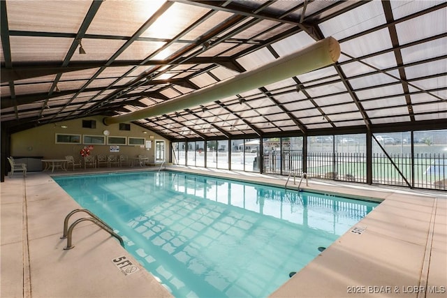 view of pool featuring glass enclosure