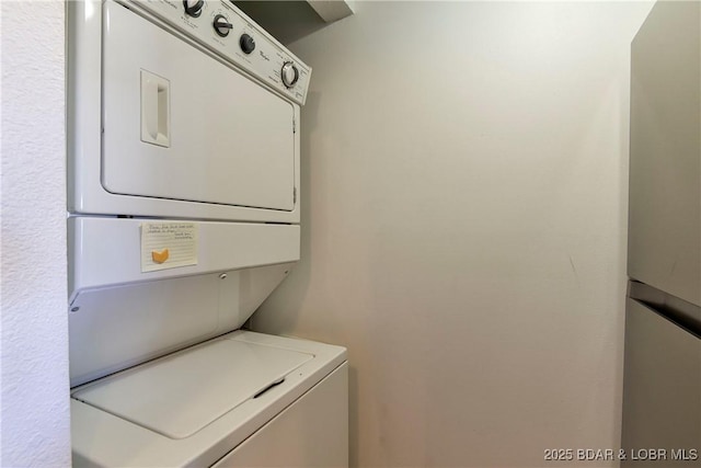 laundry area with stacked washer / drying machine