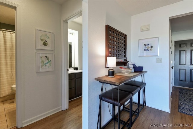 interior space featuring wood counters, light hardwood / wood-style flooring, and a breakfast bar