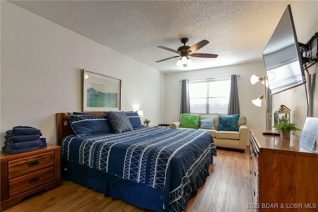 bedroom with multiple windows, hardwood / wood-style floors, and ceiling fan