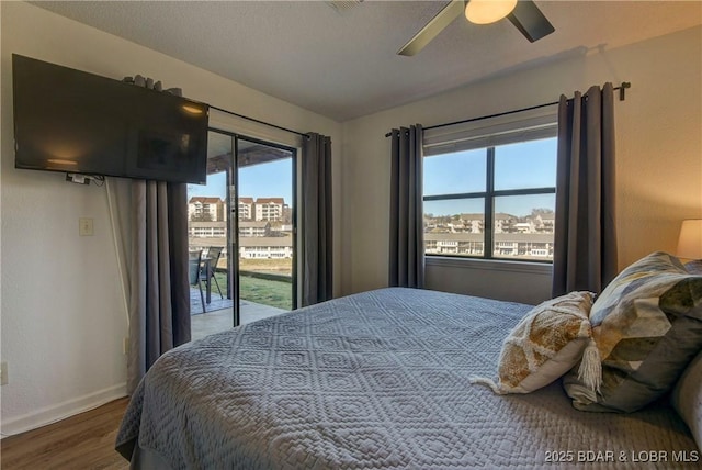 bedroom featuring ceiling fan, access to exterior, and hardwood / wood-style floors