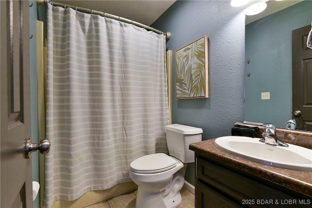 bathroom with tile patterned flooring, vanity, a textured ceiling, and toilet