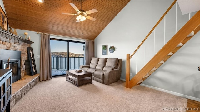 carpeted living room with ceiling fan, high vaulted ceiling, wooden ceiling, and a fireplace