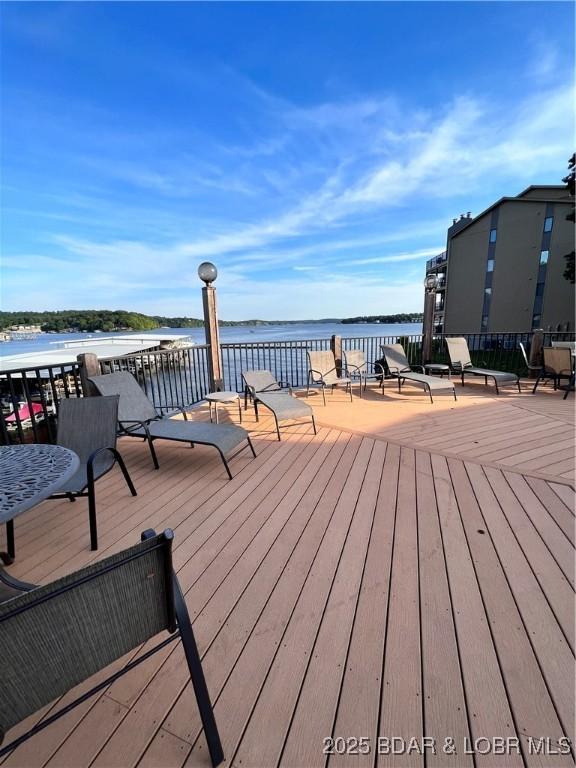 wooden terrace featuring a water view