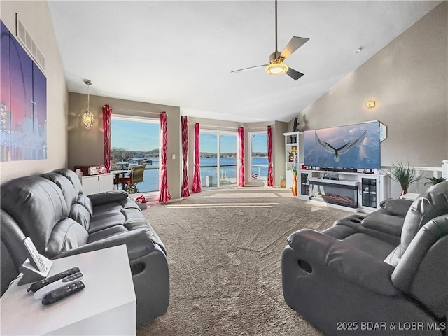 carpeted living room with vaulted ceiling and ceiling fan