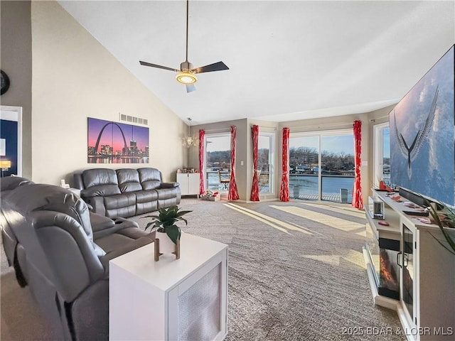 living room featuring ceiling fan, carpet, plenty of natural light, and high vaulted ceiling