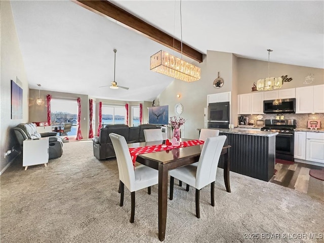 carpeted dining room featuring beamed ceiling, ceiling fan, and high vaulted ceiling