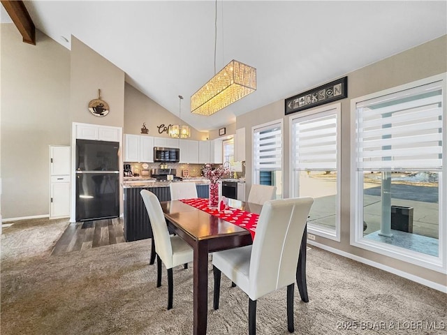 carpeted dining space featuring high vaulted ceiling, sink, and beam ceiling