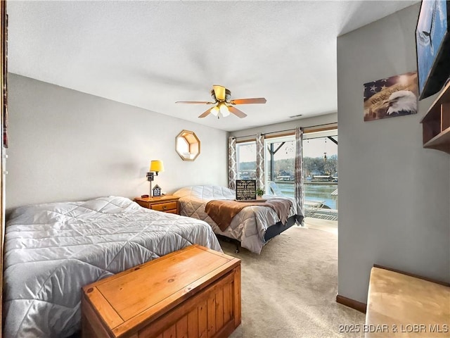 bedroom with light colored carpet, access to exterior, and ceiling fan