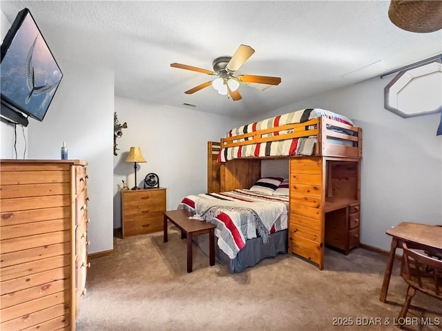 bedroom featuring a textured ceiling, ceiling fan, and carpet