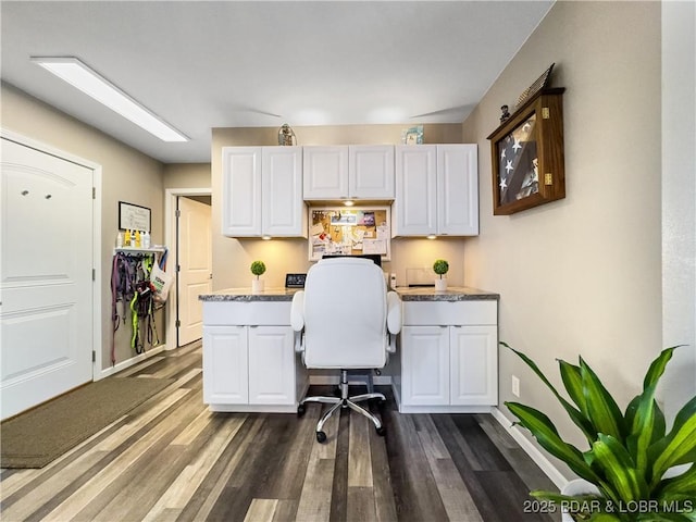 office space with dark wood-type flooring and built in desk