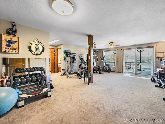 workout area with ceiling fan, carpet floors, and a textured ceiling