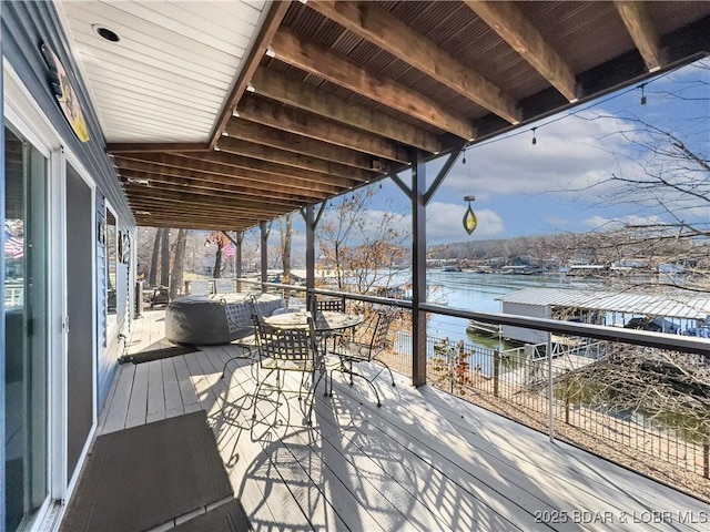 wooden terrace featuring a water view