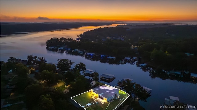 aerial view at dusk with a water view