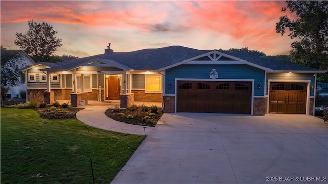 craftsman inspired home featuring a lawn and a garage