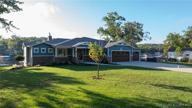 view of front of home with a front lawn and a garage