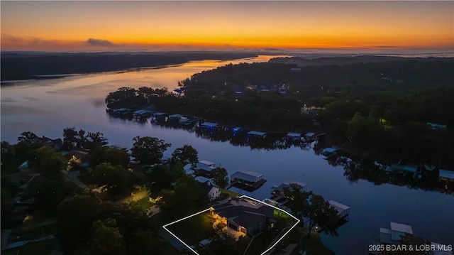 aerial view at dusk with a water view