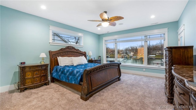 carpeted bedroom featuring a water view, baseboards, and recessed lighting