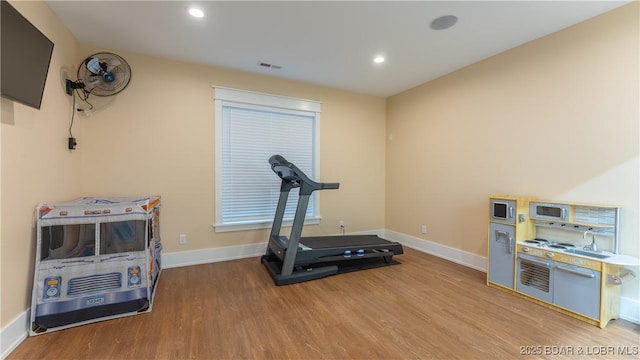 workout area featuring hardwood / wood-style floors