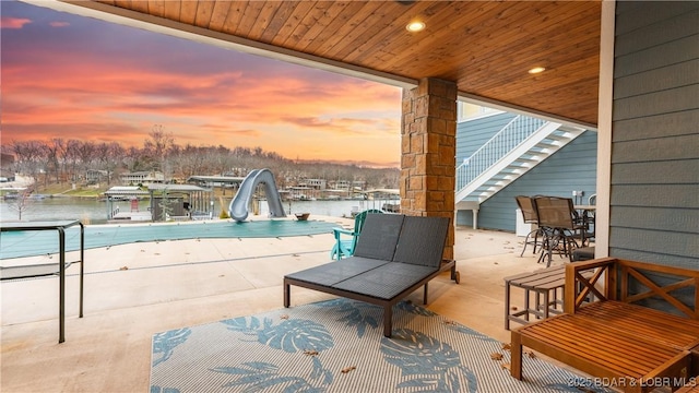 patio terrace at dusk with a water view