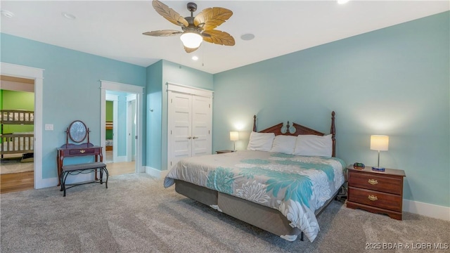 carpeted bedroom featuring a closet and ceiling fan