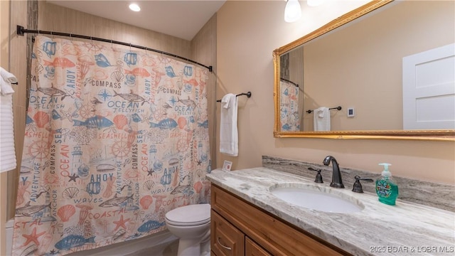 bathroom featuring toilet, vanity, and a shower with curtain