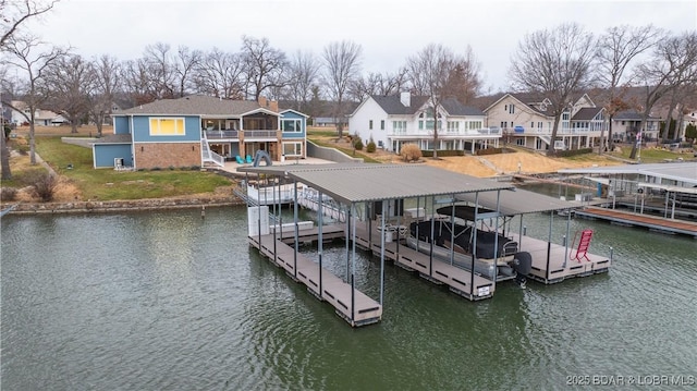 view of dock featuring a yard and a water view