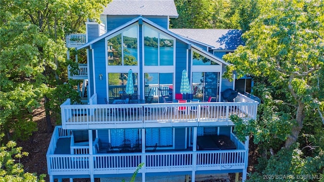 rear view of property featuring a balcony