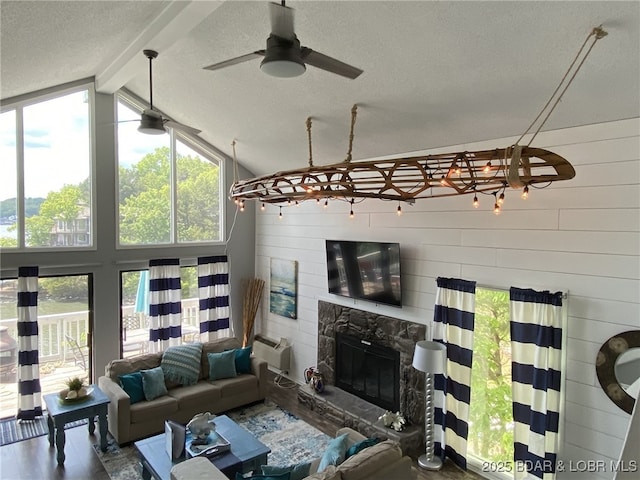 living room featuring vaulted ceiling with beams, a high end fireplace, wooden walls, and a healthy amount of sunlight