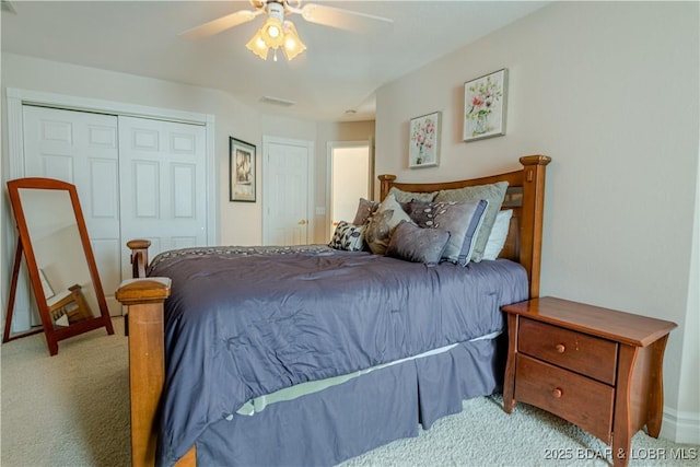 bedroom featuring ceiling fan, light colored carpet, and a closet