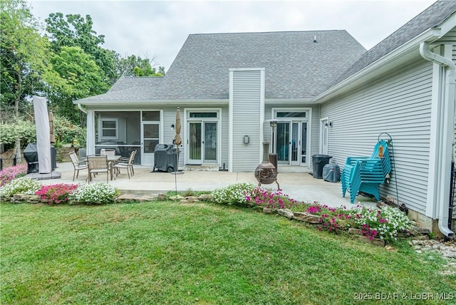 back of house featuring a patio and a yard