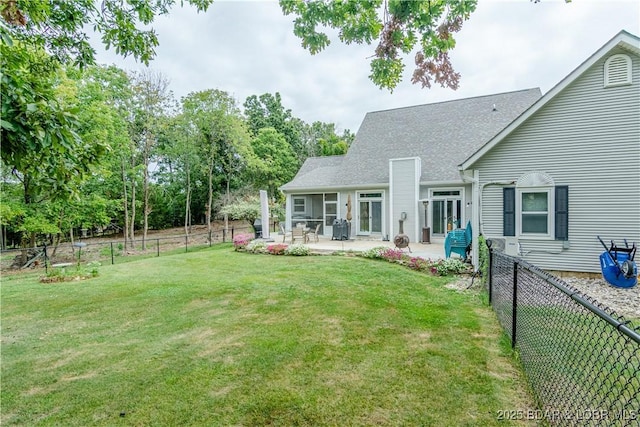 rear view of property with a patio and a yard