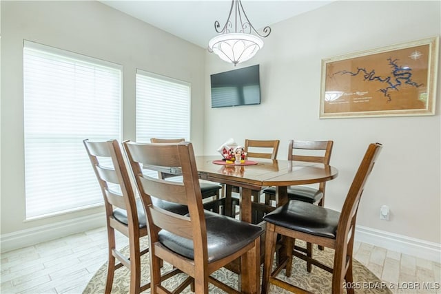 dining room with wood-type flooring and a chandelier