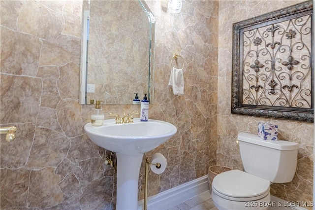 bathroom with tile walls and toilet